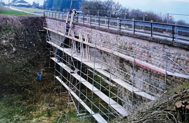 Steingewölbebrücke, Gerüst in Stufen an der Böschung aufgebaut